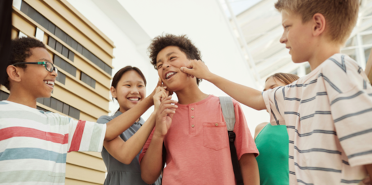 Drie Kinderen Knijpen In De Wang Van Een Lachende Vierde Kind 2